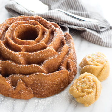 baked rose Bundt with two rose cakelets, dusted in powdered sugar
