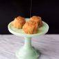 Three baked vanilla rose cakes in cake stand, drizzled with honey