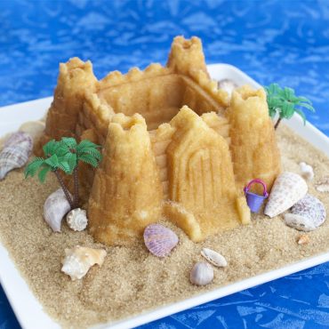 Baked Castle Bundt on "sand" brown sugar, sea shells and mini palm trees as decoration