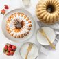 Baked Party Bundt, glazed with pan, strawberries and plates