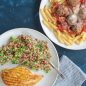 Plate with grilled chicken and quinoa salad, plate with pasta, spaghetti sauce and meatballs