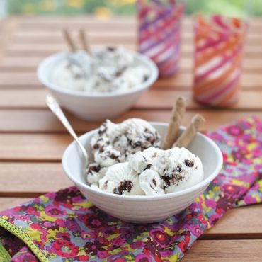 Chocolate chip ice cream in bowl with cookies