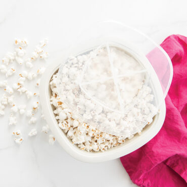 Nordic Ware white microwave popcorn popper filled with fluffy popped kernels