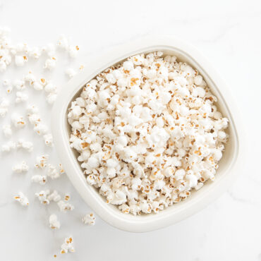 Nordic Ware white microwave popcorn popper filled with fluffy popped kernels