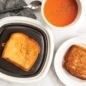 Grilled Cheese on QuickCrisp, one grilled cheese on plate with tomato soup.