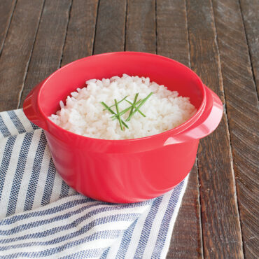 White Nordic Ware Multi Boiler with cooked white rice, plastic microwave cookware with fitted lid