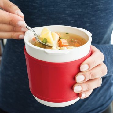 Soup Mug filled with heated soup, hand holding mug on -the- go