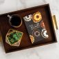 The BundtÂ® Cookbook on wooden tray with cup of coffee and succulent plant