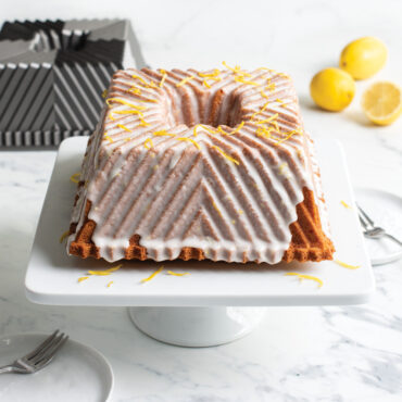 Glazed Bundt Squared cake on white cake stand