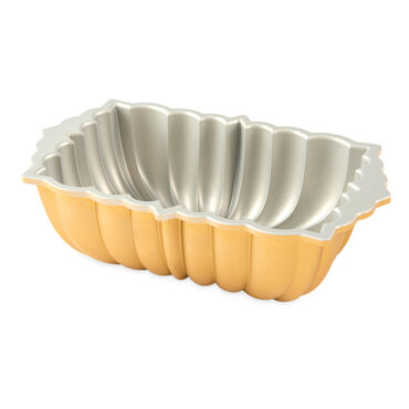 Nordic Ware aluminum fluted loaf pan interior view, silver nonstick coating with decorative ridged sides