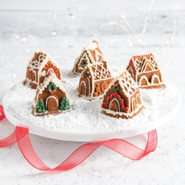 Golden brown gingerbread houses from Nordic Ware Cozy Village pan with white icing details