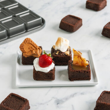 brownie bites baked in Nordic Ware pan with various toppings