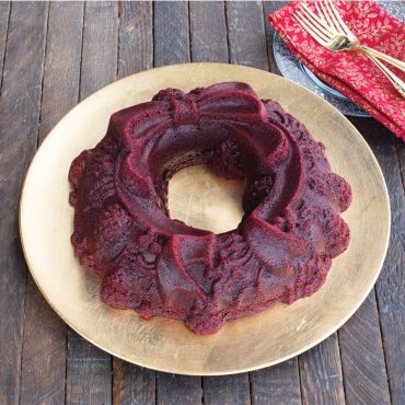 Baked red velvet holiday Wreath Bundt on serving plate