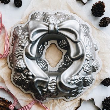 Cast aluminum Wreath BundtÂ® pan, with holly and pine cone design, large bow design, and gift wrapping