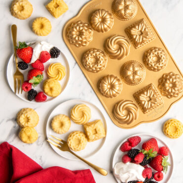 Nordic Ware gold aluminum bundt charms pan with 12 mini decorative cavities in assorted intricate designs