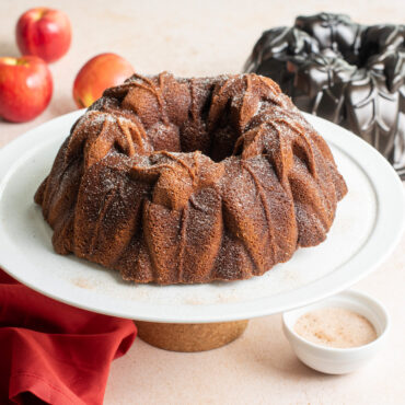 Harvest Leaves Bundt on cake stand with apples and pan in background