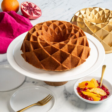 Nordic Ware gold aluminum Jubilee bundt pan with cake showing geometric diamond pattern design