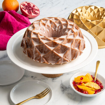 Nordic Ware gold aluminum Jubilee bundt pan with glazed cake showing geometric diamond pattern design