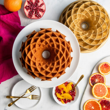 Nordic Ware gold aluminum Jubilee bundt pan with cake showing geometric diamond pattern design