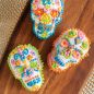 Piped bright frosting on skull cakelets