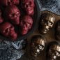 Baked red velvet skull cakelets on plate, pan on the side