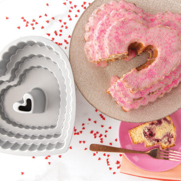 Baked vanilla Tiered Heart Bundt cake with light pink glaze and Tiered Heart Bundt Pan, Interior View