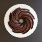 Top view of baked chocolate cake with chocolate glaze in grooves
