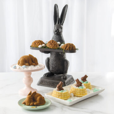 Nordic Ware ornamental egg cakelet pan with baked Easter treats including bunny, egg, and basket-shaped cakes displayed
