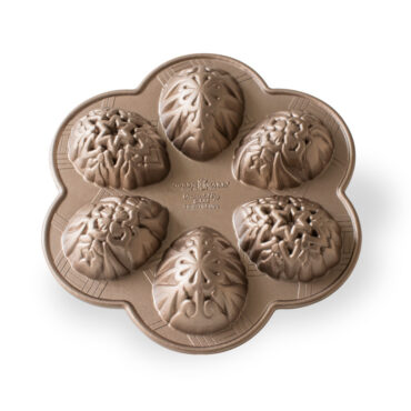 Nordic Ware cast aluminum egg-shaped cakelet pan with six ornate decorative cavities, natural silver finish