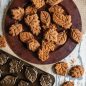 Baked leaf spice cakes and granola bites on serving plate, pan next to plate