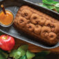 Baked apple cinnamon loaf cake on serving board