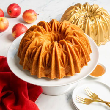 golden brown bundt cake on pedestal baked with nordic ware cut crystal bundt pan