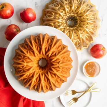 golden brown bundt cake on pedestal baked with nordic ware cut crystal bundt pan