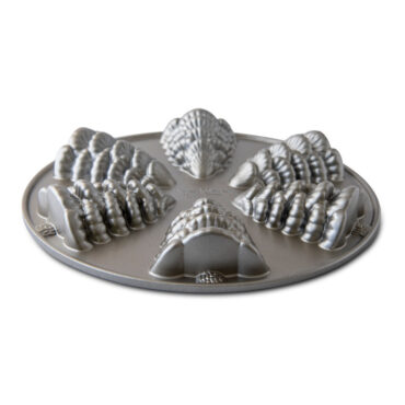 Nordic Ware aluminum evergreen tree shaped cakelet pan with six cavities, natural silver finish, angled view