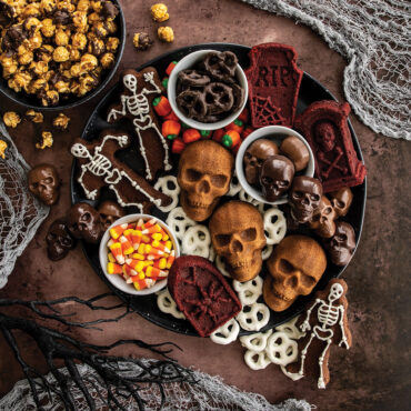 Halloween dessert board with cakes and candies on a round platter