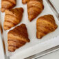 Baked croissants on perforated half sheet