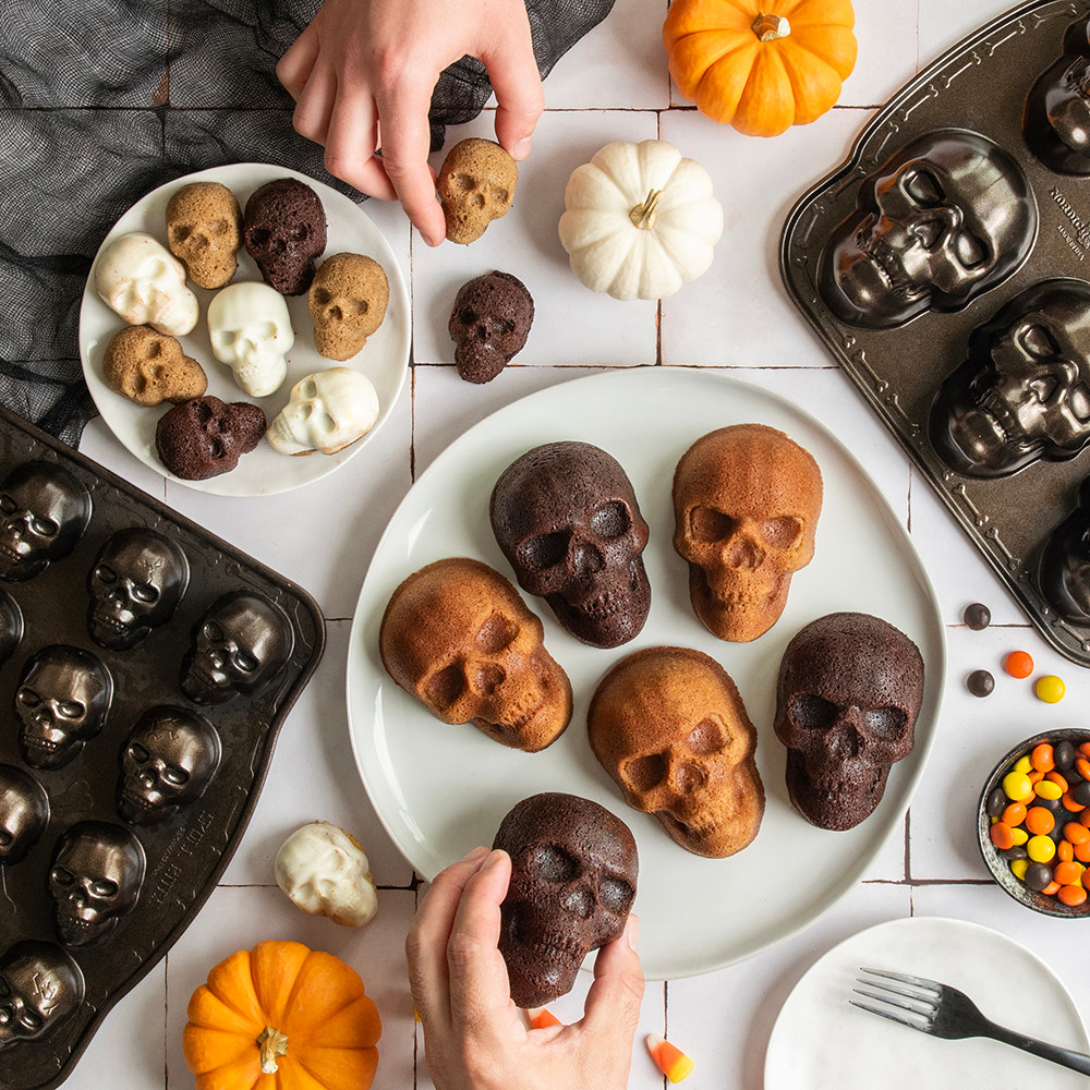 Image of baked ornament cakelets on a cooling rack with pan on surface