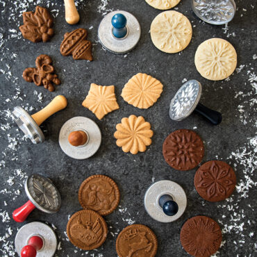 Baked stamped cookies showcasing holiday designs on surface