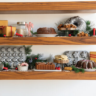 Holiday teacakes baked in Nordic Ware aluminum cakelet pan displayed on festive shelves with winter decorations