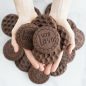 Baked chocolate stamped cookies in hand