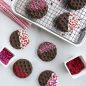 Baked stamped cookies dipped in white chocolate, sprinkles, baking sheet