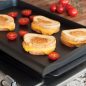Grilled cheese sandwiches and grilled tomatoes on griddle on stovetop