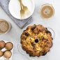 baked egg breakfast dish in cake pan with coffee in cups, fresh eggs