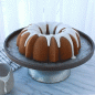 Moving GIF, hand pouring glaze over Bundt cake on stand