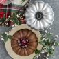Baked Bundt with cranberries in the middle, with Bundt in background