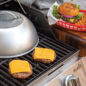 Dome lid on grill with finished cheese burgers