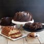 Four different version of Heritage cakes - baked chocolate cakes 10 cup, 6 cup, bundtlets, vanilla loaf with nuts, all on serving plates
