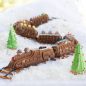 Baked Nordic Express Train cakes decorated with piped frosting and candies, on a pretzel train track and snow scene