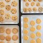 4 prim sheet pans with a variety of baked cookies