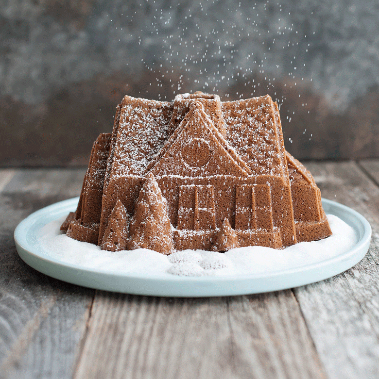 Powdered sugar being sprinkled onto gingerbread House Bundt, moving GIF